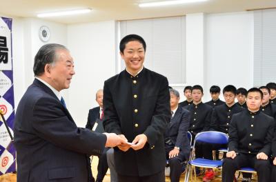 市長（左）から激励金を受け取る田中奨也主将（中央）